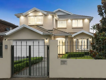 Luxury home exterior with landscaped gardens and feature lighting