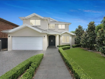 Sleek front yard landscaping with stone pathways and lighting
