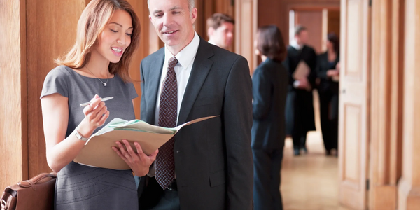 Business colleagues reviewing documents in a professional setting.