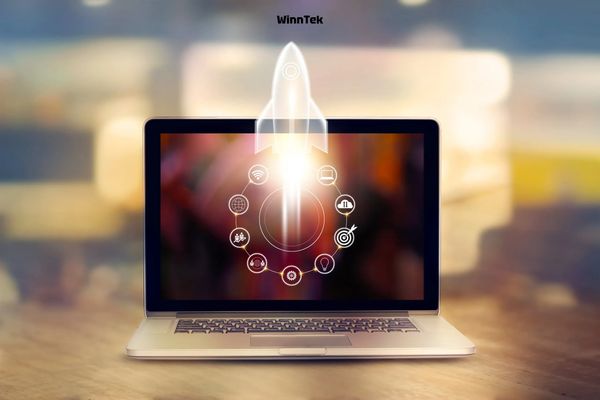 Rocket launching from laptop screen symbolizing tech startup growth.
