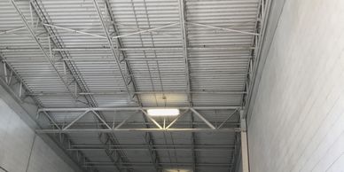 Interior of a large industrial warehouse with metal walls and structural beams.