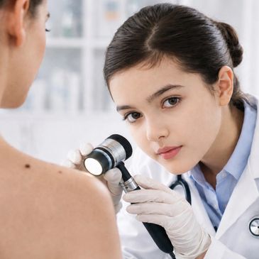 Dermatologist examining a patient's skin with a dermatoscope.