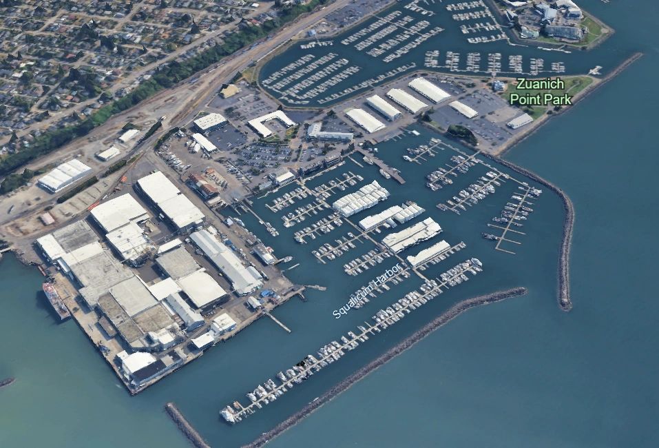 Aerial view of a marina with docks and boats.