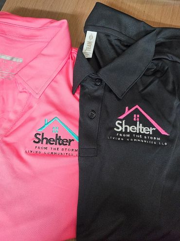 Pink and black polo shirts with Shelter logo and slogan embroidered.