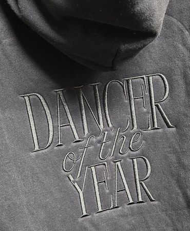 Black hoodie with "Dancer of the Year" embroidered on it.