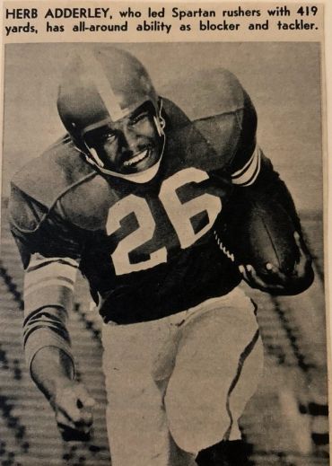 Herb Adderley in football gear, running with the ball.
