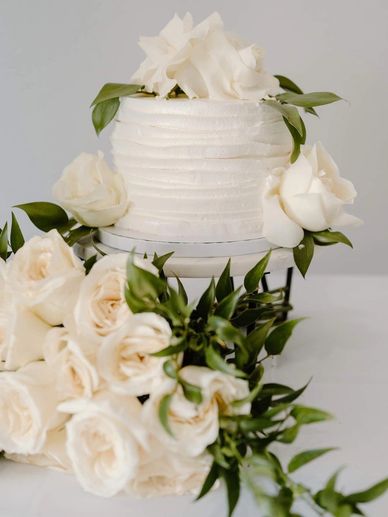 Elegant White Cake with Delicate Floral and greenery accents