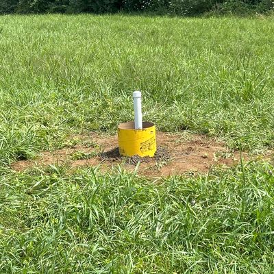 A mounting system for a pole placed into the ground.