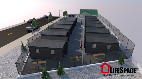 A small community of compact black houses enclosed by a fence with outdoor benches.