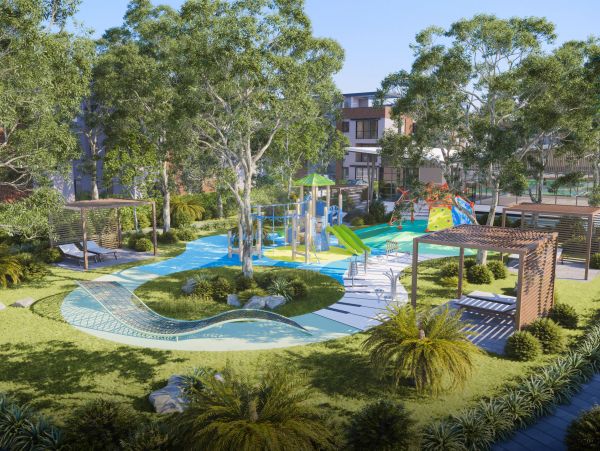Modern outdoor playground with slides, climbing walls, and shaded seating areas.