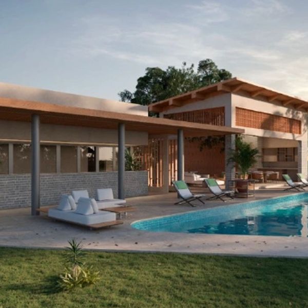 Modern house with outdoor pool and seating area at sunset.