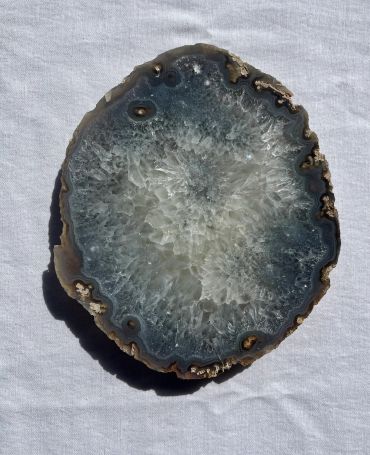 A polished geode slice with crystal formation.