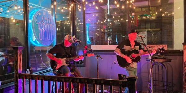 Musicians on stage at MJ's Chill Spot, a local bar at the entrance to Historic Printer's Alley