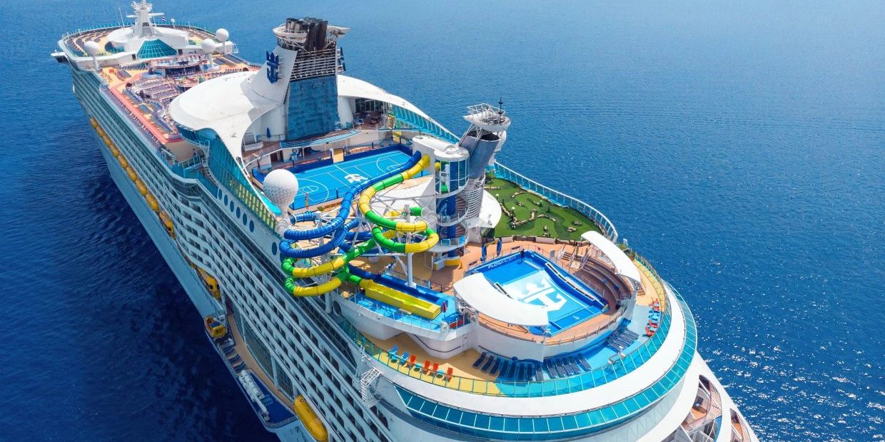 A large cruise ship with water slides and sports courts.