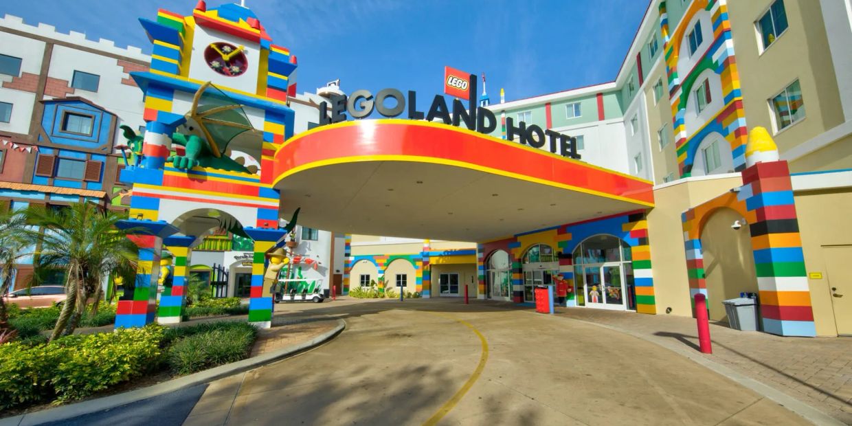 Entrance of the colorful LEGOLAND Hotel under a clear blue sky.