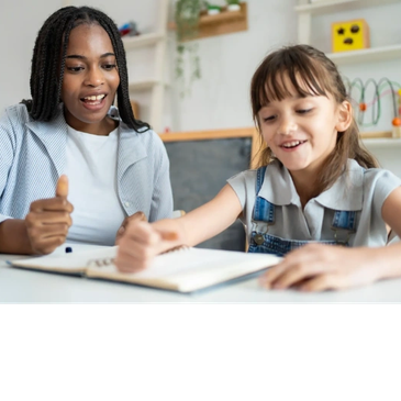 Teacher helping young student with homework.