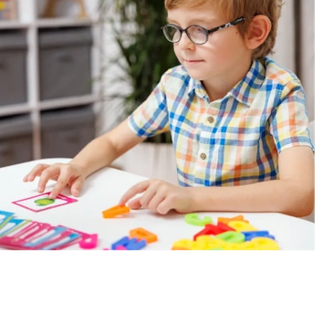 Child playing educational game with colorful pieces.