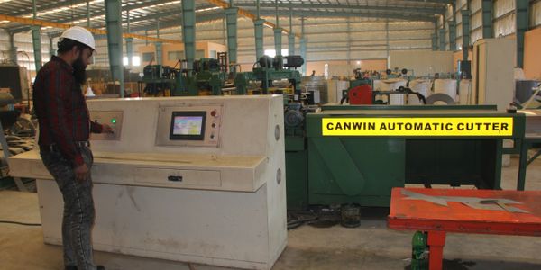 An engineer setting up automatic cutter (CNC).