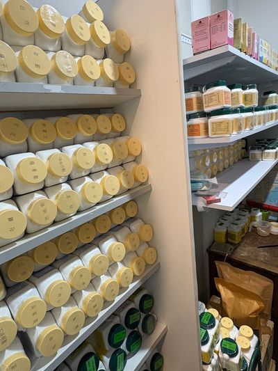 Shelves filled with jars and containers in a storage room.
