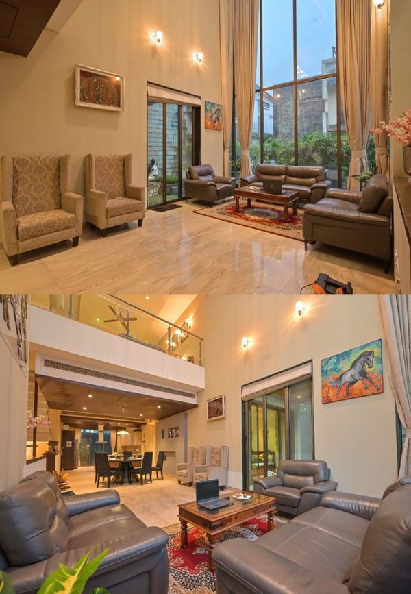 Spacious modern living room with large windows and comfortable seating.