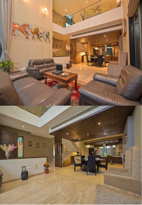 Modern double-height living and dining room with leather sofas and elegant decor.
