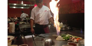 Picture of a chef cooking a hibachi meal. Clicking on the picture will take you to the hibachi menu.