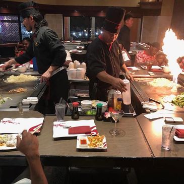 Picture of 2 chefs preparing hibachi dinner at the table