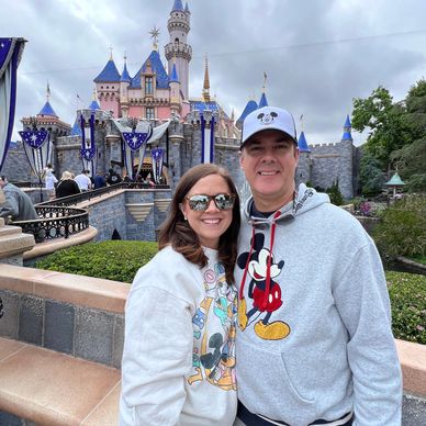 Disney couple in front of Sleeping Beauty Castle