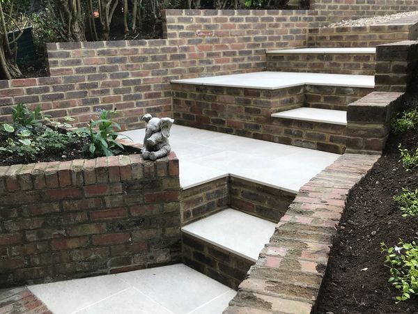 Garden stairs made from bricks and brick walls with decorative plants