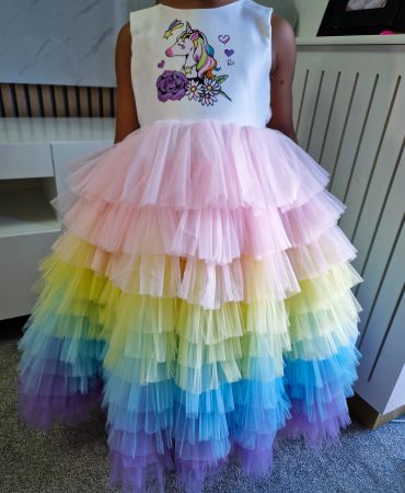 Child wearing a colorful rainbow tutu dress with a unicorn top.