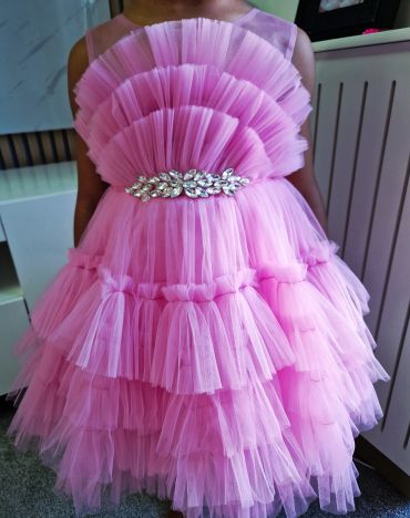 Pink layered tulle dress with jeweled belt for a child.