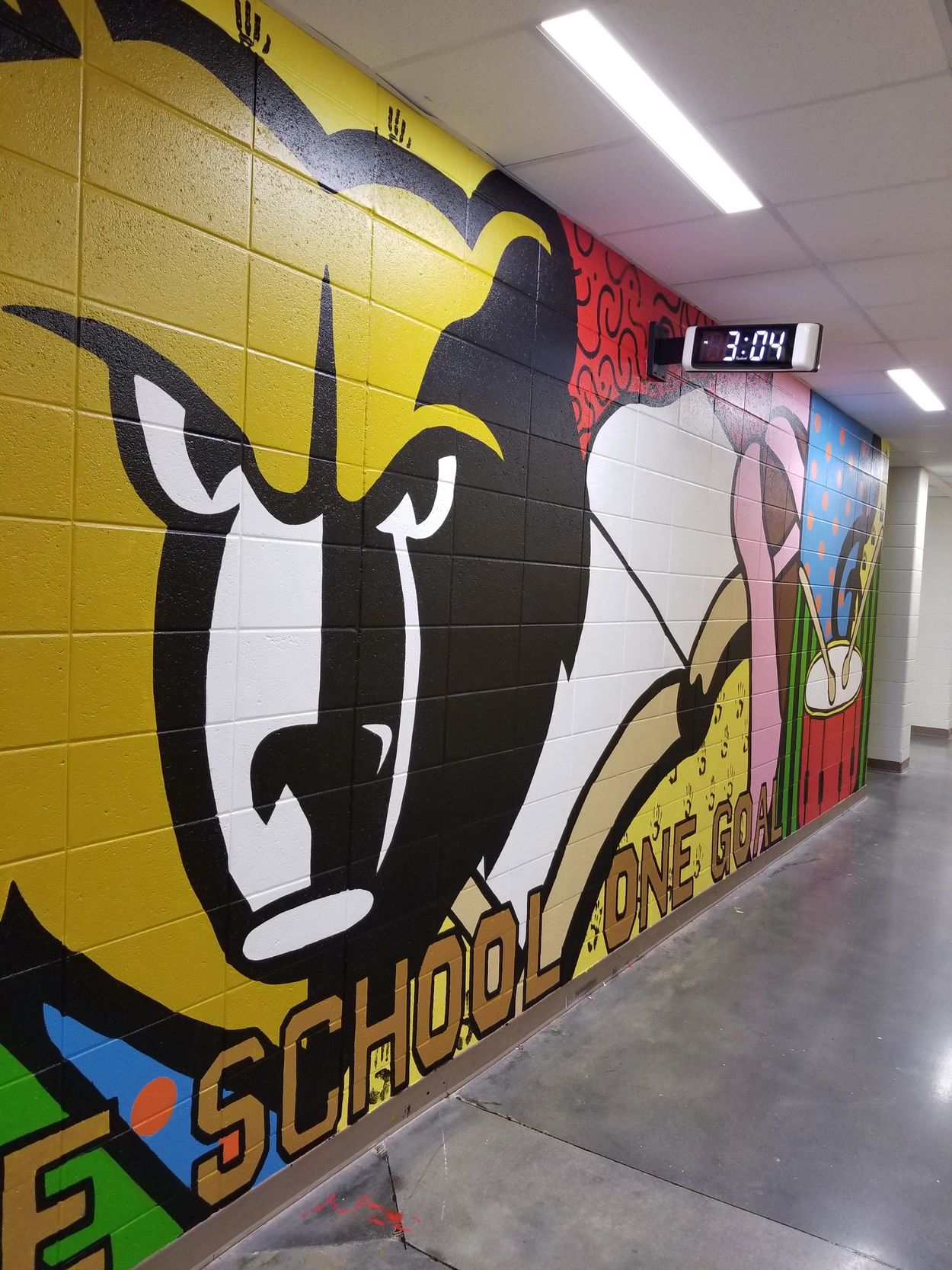 Mural of a fierce mascot in a school hallway.