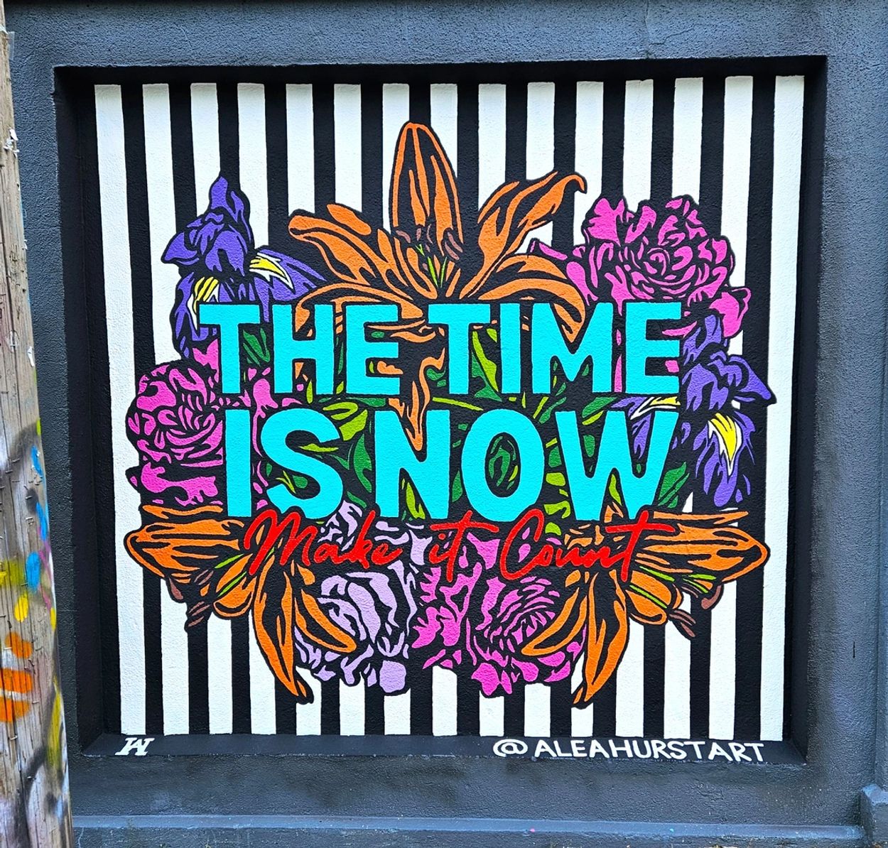 Colorful mural with motivational text and flowers.