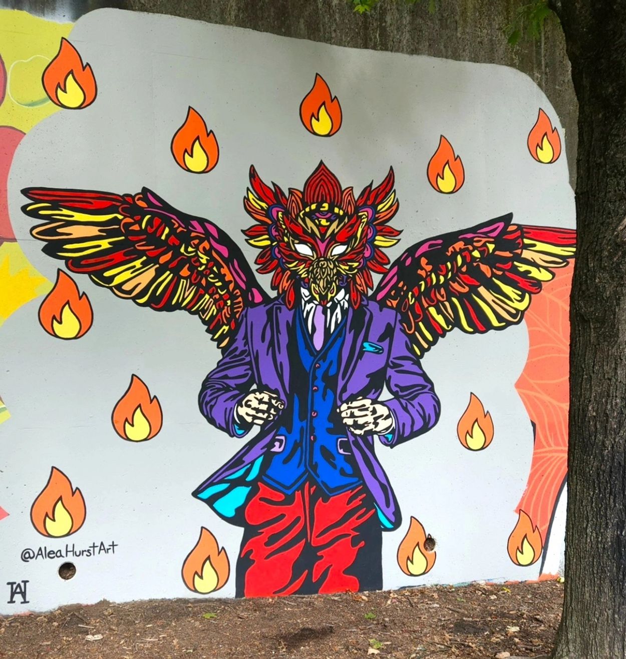 Vibrant mural of a suited figure with bird wings and a flaming head.