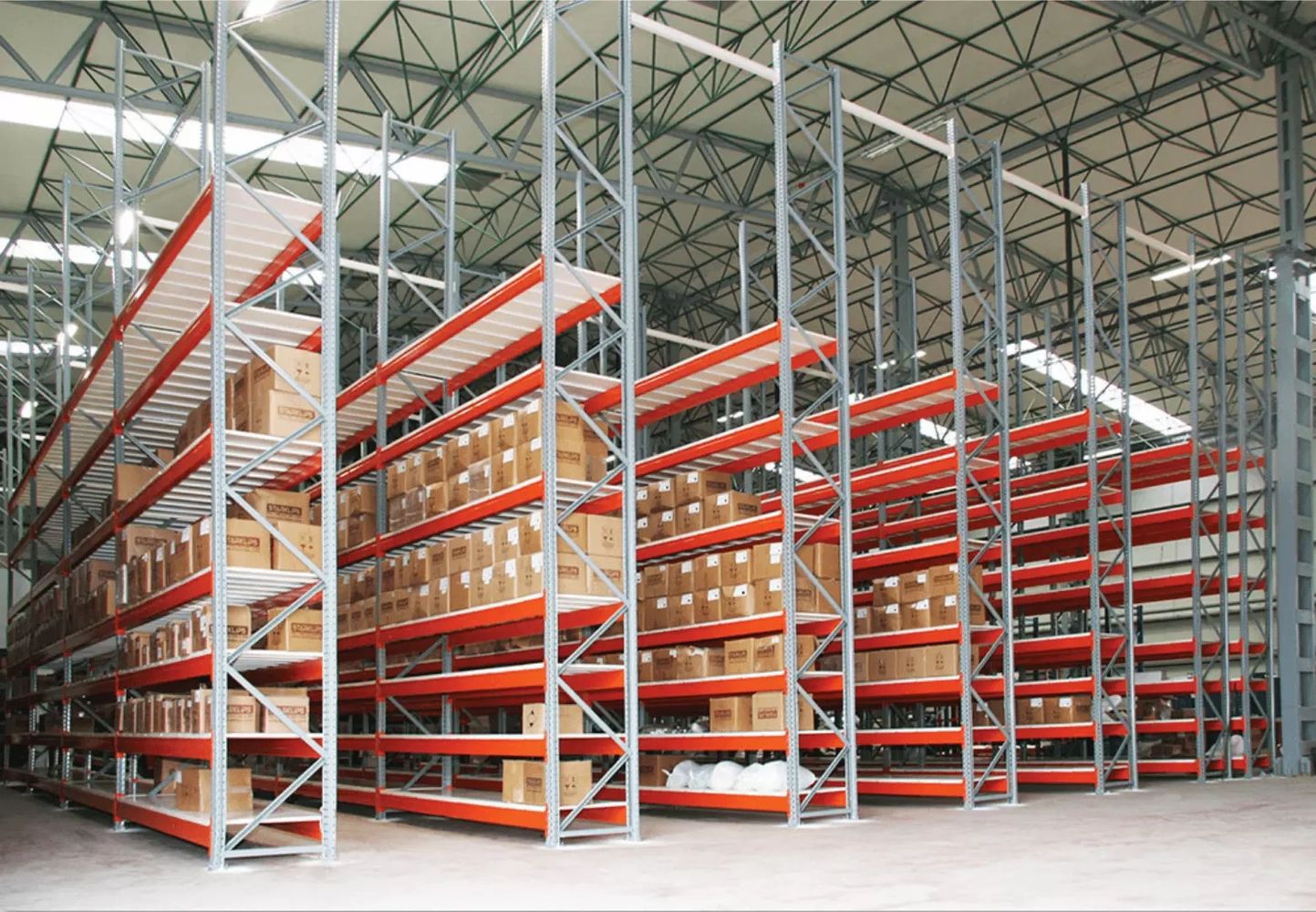 heavy-duty industrial steel shelves in large warehouse with orange beams