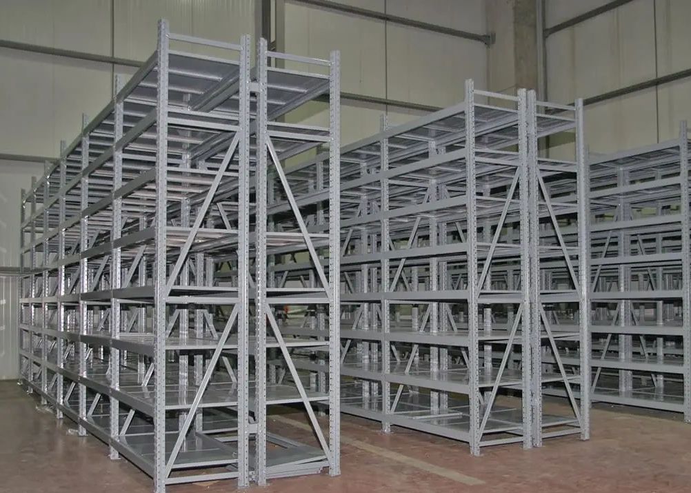 Industrial medium duty storage shelves installed in a warehouse setting.