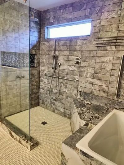 Modern bathroom remodeling in Austin by Raptor Electric and General Contractor featuring custom tile