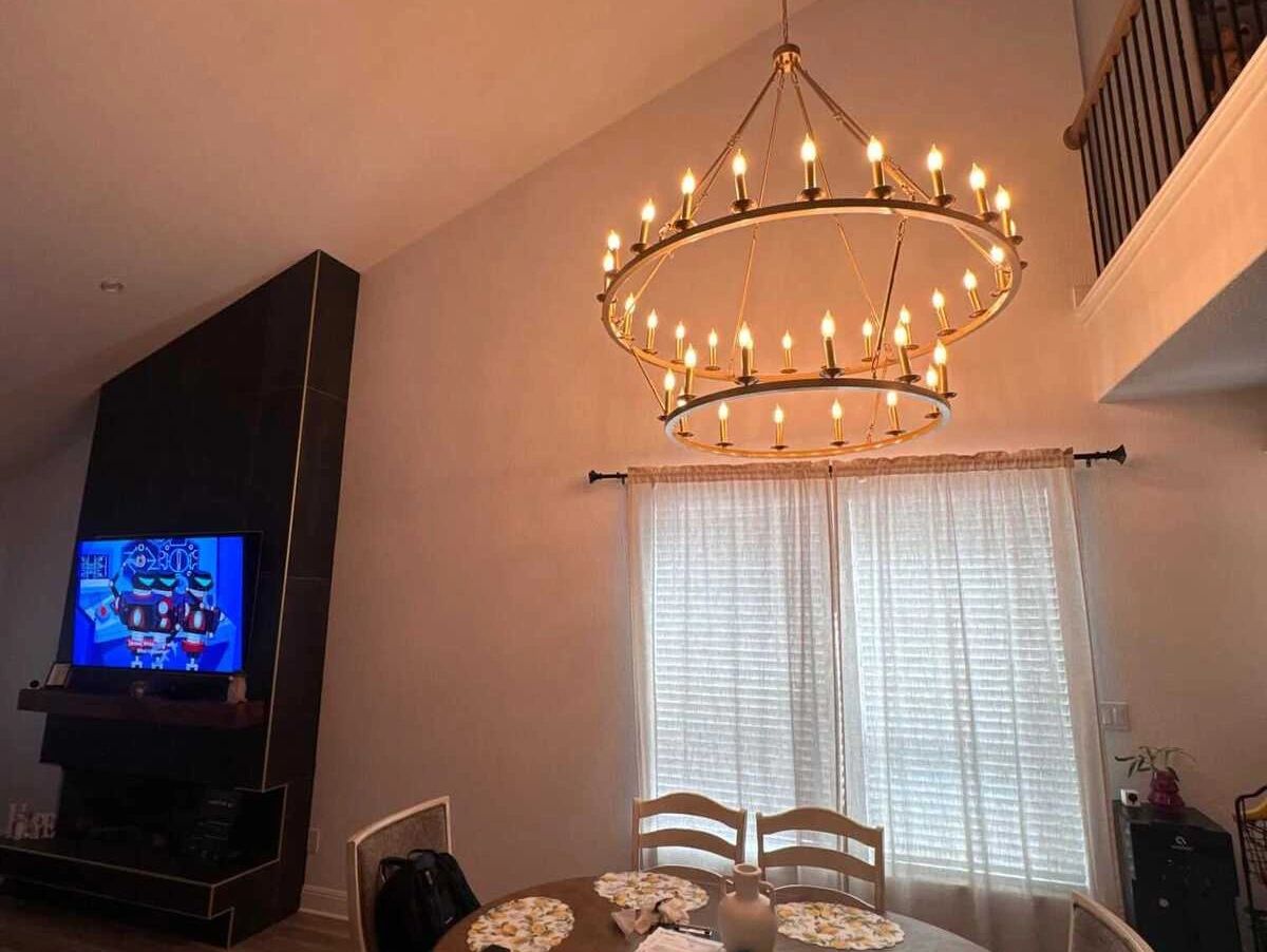 Master Electrician Installing Chandelier in Austin