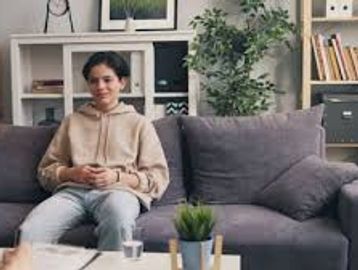 Teen sitting on couch during a therapy session.