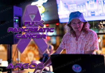 DJ playing music with a pancreatic cancer awareness message and purple ribbon.