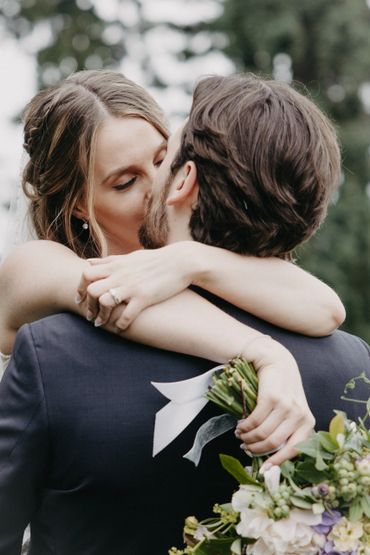 Bride and groom embracing during a wedding moment.