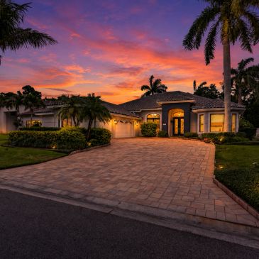 Beautiful house at sunset with palm trees.
