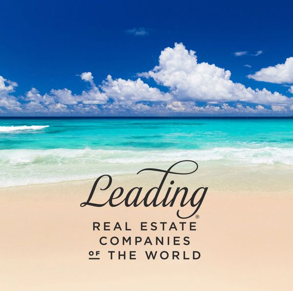 Tropical beach with real estate company logo.