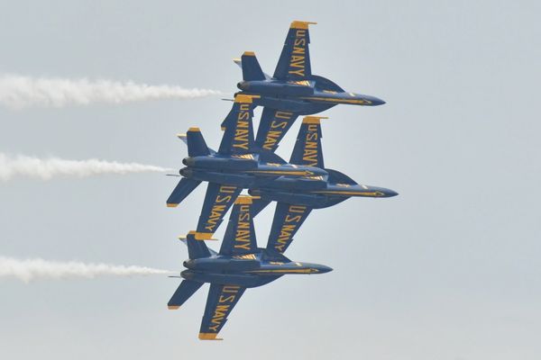 Four US Navy jets in tight formation flying.