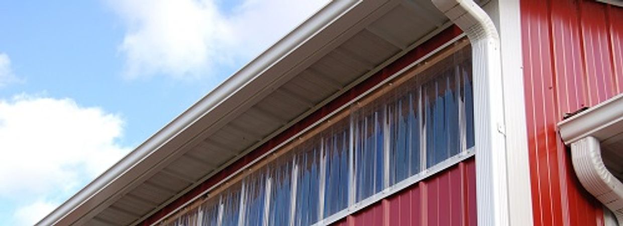 Rain gutter and downspout on corner of pole barn