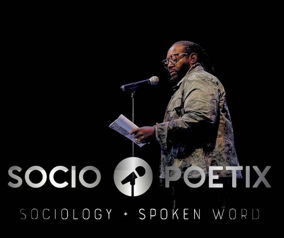 Poet performing spoken word poetry on stage with microphone.