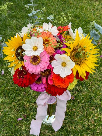 Bright bouquet of sunflowers and colorful flowers in a garden.