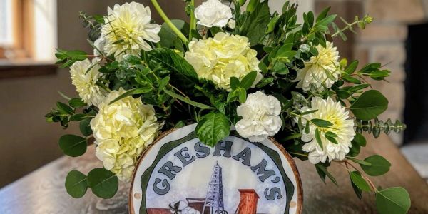 Floral arrangement in a Gresham's container.