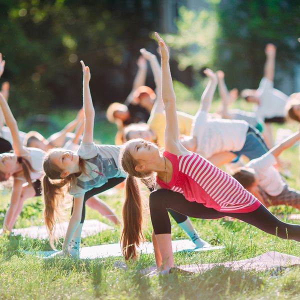 Kids doing a yoga class outside
