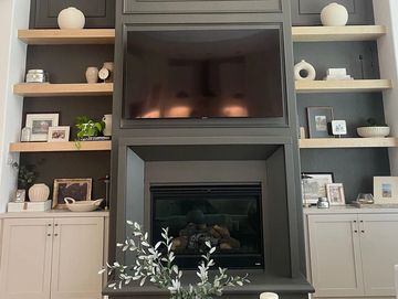 Custom built media room cabinets and floating shelves 